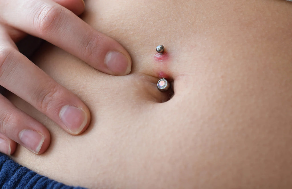 young teenage girl looking at the rejected belly button piercing